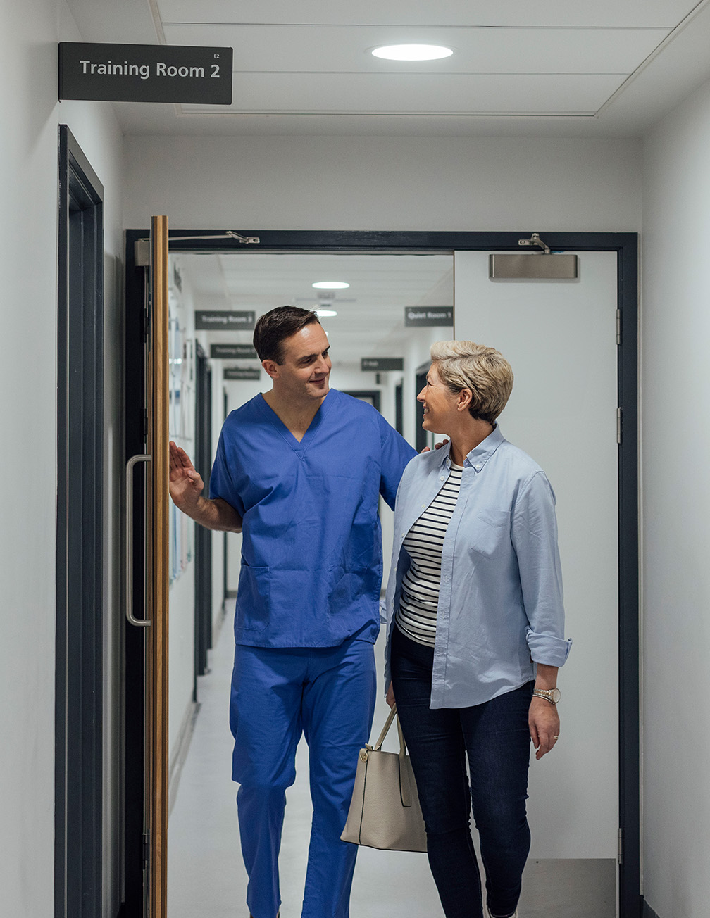 doctor walking with patient in hallway