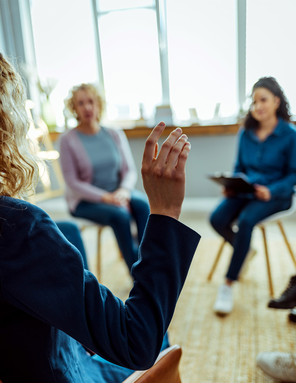 hand raised with group in background
